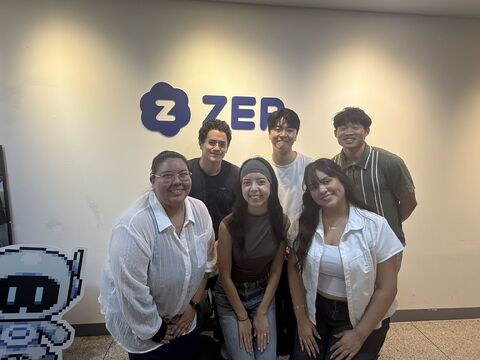 Isaac Lee with the ZEP team in front of the ZEP office sign