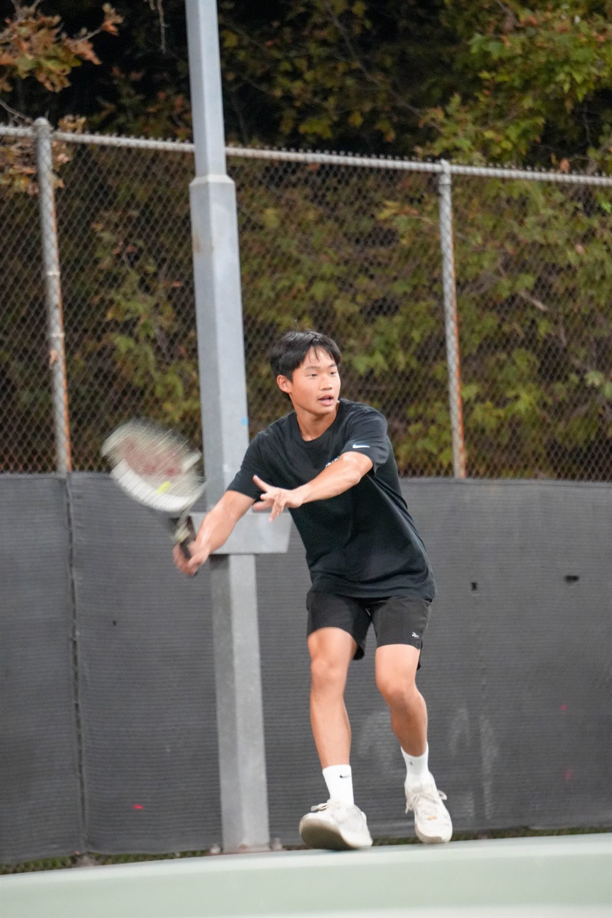 Isaac Lee hitting a forehand