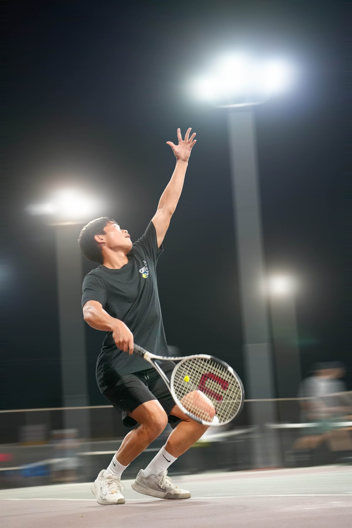 Isaac Lee serving during a match